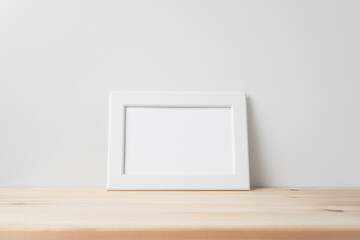 horizontal white wood photo on floor with white wall