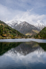 Fototapeta na wymiar Snow mountains and tranquil lake