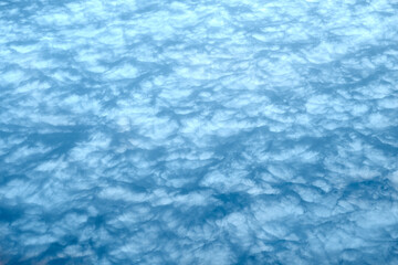 Cloudy pattern, texture. Blue clouds in the sky are painted in a solid color. Abstract background