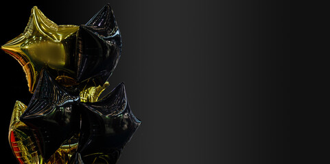 A group of black and gold balloons on a black background with copy space