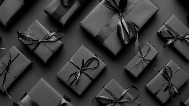 Elegant black Christmas theme. Wrapped gifts in black matte paper with ribbon