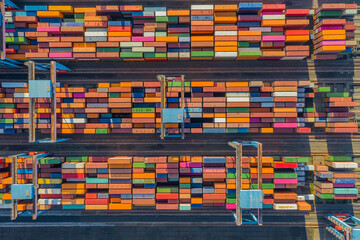 Aerial view of storage by container terminal with containers and container bridges. View of area...