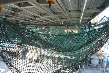 Safety net install under the scaffold floor to prevent drop objects from work at height.