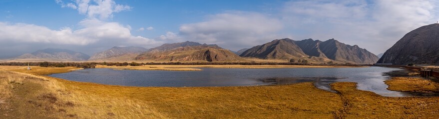 Yellow grassland, mountains and lakes in autumn