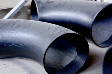 Black metal pipes and adapters of different diameters for gasification or water supply. Industrial...