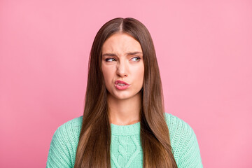 Photo of displeased pretty young woman look empty space dislike smell isolated on pastel pink color...