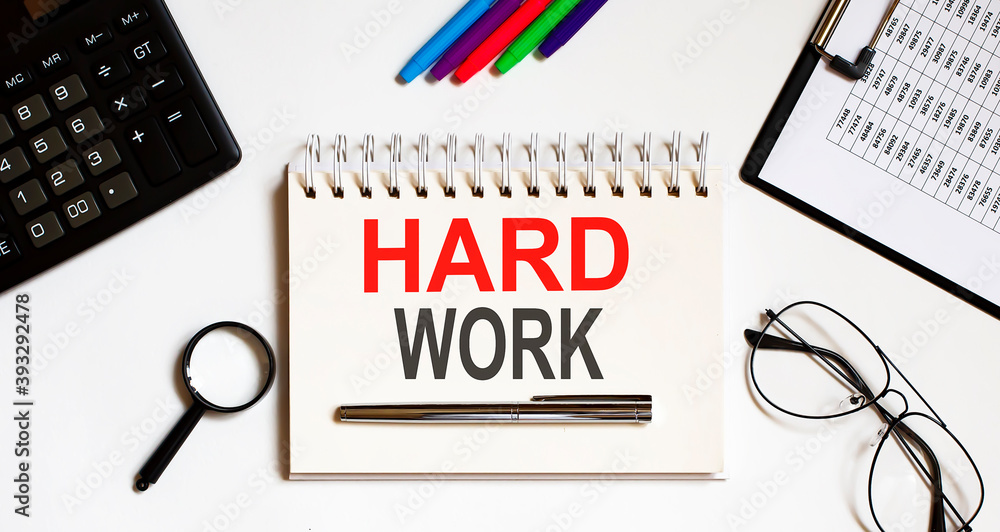 Poster hard work text in the office notebook with office tools