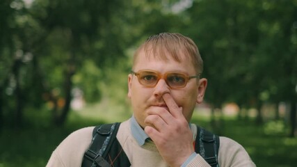Nerdy fat guy is walking to school. Concept of loser nerd at university. Close up