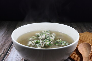 Hot clear soup of minced pork with coriander and vermicelli in the bowl. Famous traditional soft and light menu for easy digestion. 