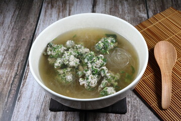 Hot clear soup of minced pork with coriander and vermicelli in the bowl. Famous traditional soft and light menu for easy digestion. 