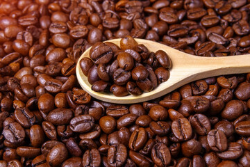 coffee beans close-up in a wooden spoon. selective focus. food background