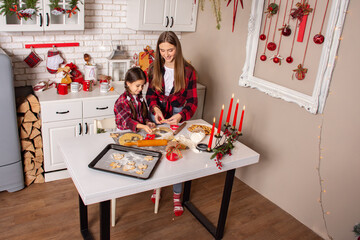 Christmas cookies. Kitchen on Christmas eve. Two sisters make Christmas cookies and have fun playing flour .