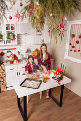 Christmas cookies. Kitchen on Christmas eve. Two sisters make Christmas cookies and have fun playing flour .