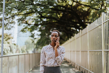 Serious black lady talking on the phone