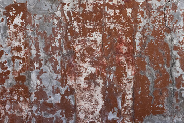 Old shabby painted red and grey concrete wall surface texture macro