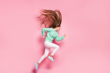 Full length profile photo of charming running person hurry wear teal sweater isolated on pink color...