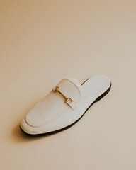 White lather loafer mules shoes on beige