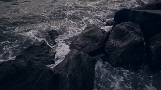 Close up shot of the waves hitting the rocks 