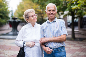 mature couple of man with a woman strolling outdoor in park