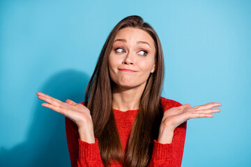 Photo of confused girl dont know answer shrug shoulders wear pullover isolated over blue color...