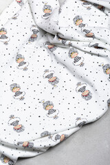 White fabric with a children's pattern on a light background