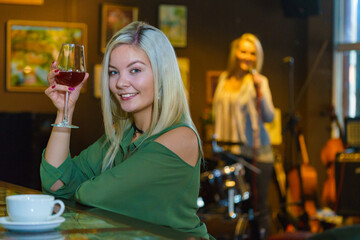 Girl with alcohol glass in pub club