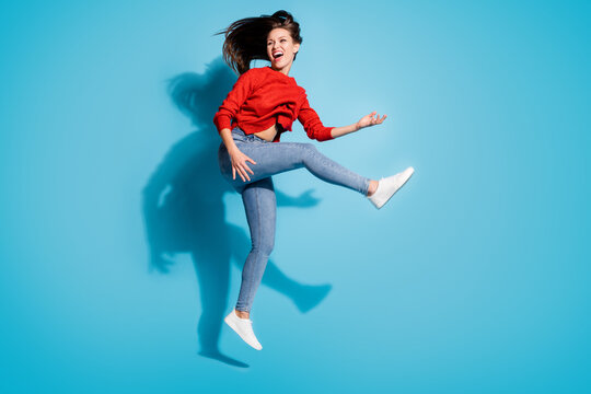 Full size photo of funky crazy lady jump flight play imaginary guitar musician isolated blue color background