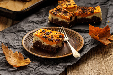Delicious pumpkin cake with cheese cream and cacao or chocolate on the top