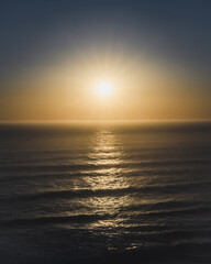 Fototapeta premium Sun setting over a sea