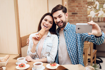 Young Couple Taking Selfie on Smartphone Cafeteria