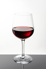 Red wine in a glass on white background
