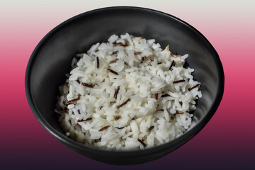 white parboiled black rice in a dark cup on plate on colorful bright pink purple violet gradient background
