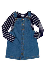 Closeup of cute sleeveless blue denim overall dress with striped t-shirt for little child girl isolated on a white background. Jeans fashion for kids.