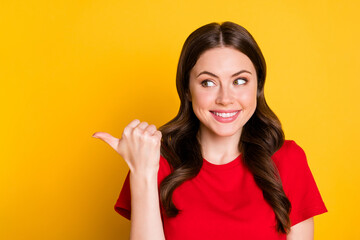 Portrait of positive girl point thumb finger copyspace wear bright outfit isolated over vivid color background