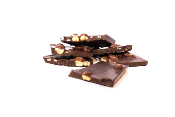 Pieces of milk chocolate with a whole nut on a white background