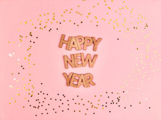 Happy new year message on a pink background with stars.