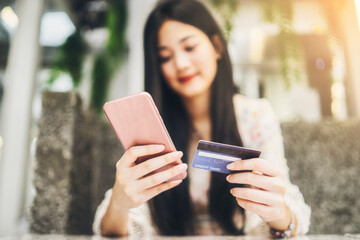 Beautiful Asian Business woman using mobile smart phone Technology online payment purchasing credit...