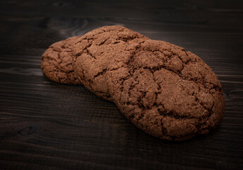 Brown cookies with cracks on a dark background