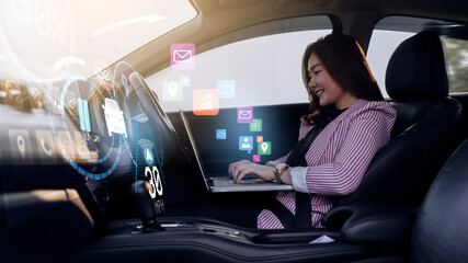 Auto pilot self driving car businesswoman working using computer laptop, HUD Head Up Display and digital instruments panel autonomous user interface navigation utility screen smart technology hologram