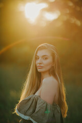 Portrait of young woman with long hair at sunset.