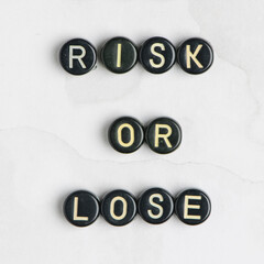 RISK OR LOSE beads message typography