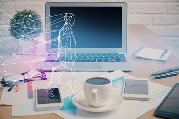 Desktop computer background in office and start up theme hologram drawing. Double exposure. Startup...
