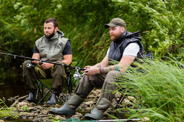 two men are fishing on the river