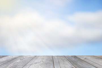 Blurred sky background with sunbeams over the table.