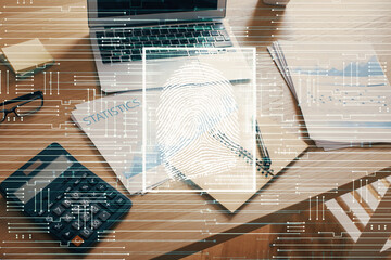 Computer on desktop in office with finger print drawing. Double exposure. Concept of business data security.