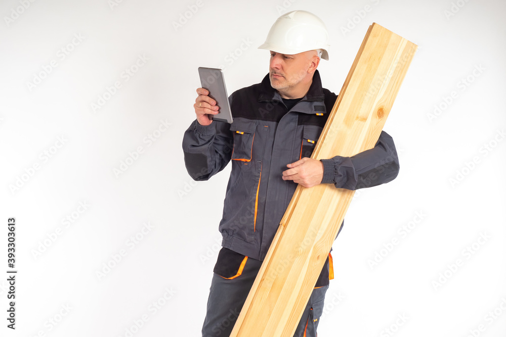 Poster builder with boards and a tablet in his hands. man in uniform of a construction worker. concept - ap