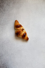 Freshly baked croissants on beautiful textured concrete background