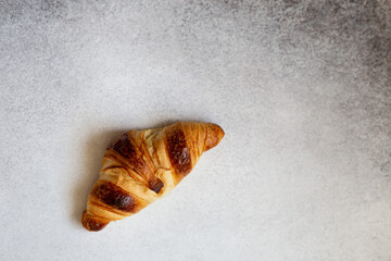 Freshly baked croissants on beautiful textured concrete background