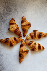 Freshly baked croissants on beautiful textured concrete background