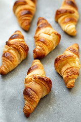 Freshly baked croissants on beautiful textured concrete background